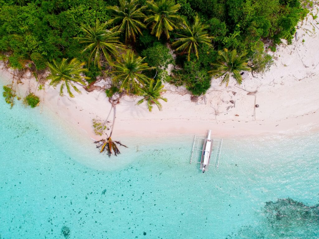 bird's-eye photography of boat on island